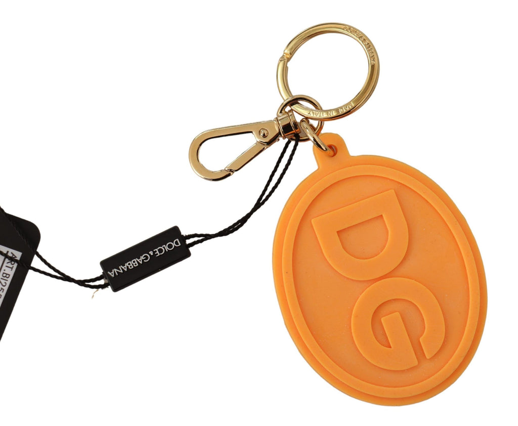 Porte-clés en métal laiton doré avec logo DG en caoutchouc orange.