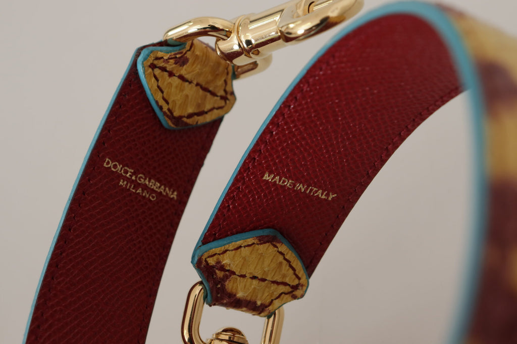 Bandoulière en cuir jaune et rouge avec détail doré.