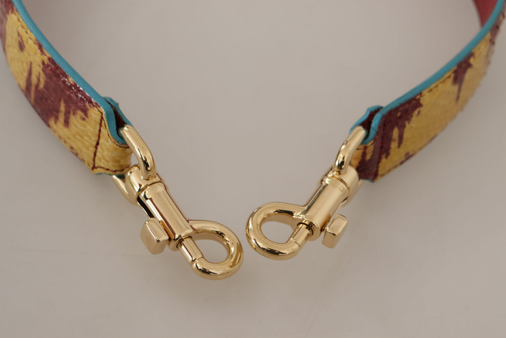 Bandoulière en cuir jaune et rouge avec détail doré.