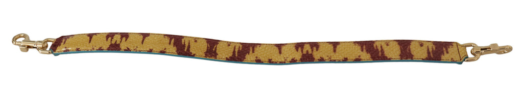 Bandoulière en cuir jaune et rouge avec détail doré.
