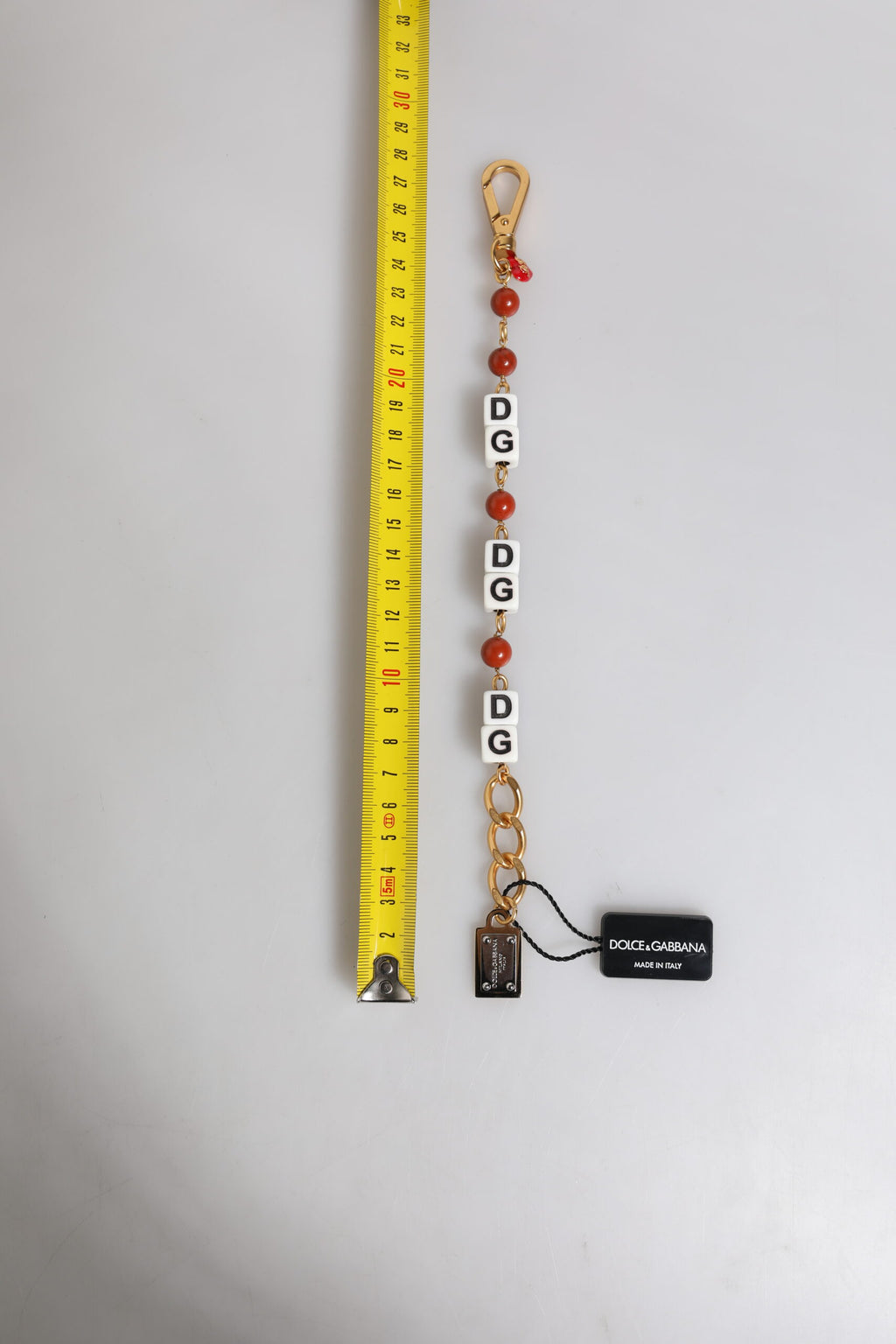 Bracelet en chaîne en laiton doré multicolore avec logo DG et dés.